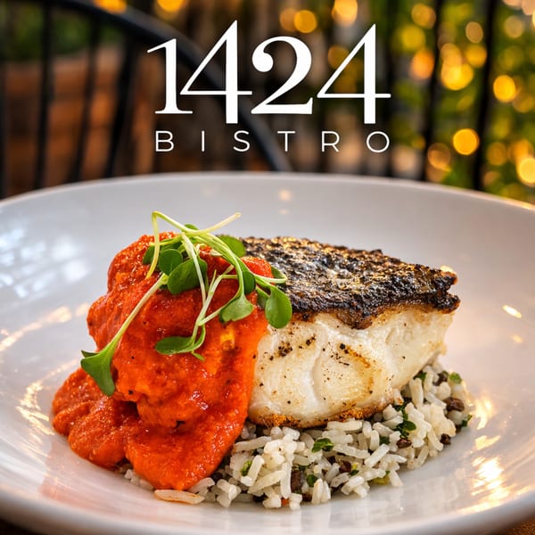 Pan-seared fish with red sauce and microgreens, served over rice, from 1424 Bistro.